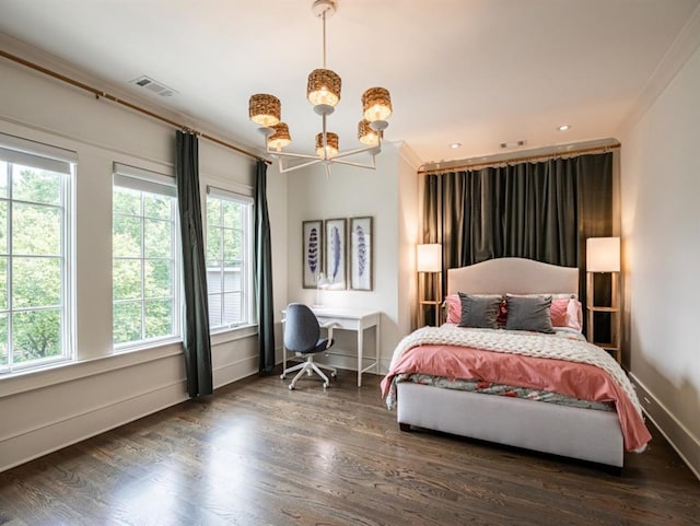 bedroom with dark wood-type flooring, visible vents, baseboards, and an inviting chandelier