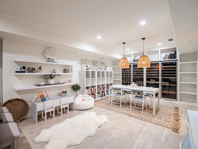 interior space featuring decorative light fixtures, visible vents, wood finished floors, and recessed lighting