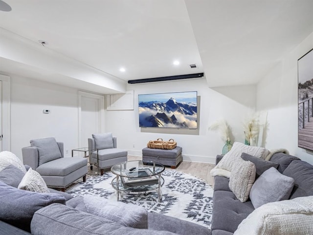 living area featuring baseboards, visible vents, wood finished floors, and recessed lighting