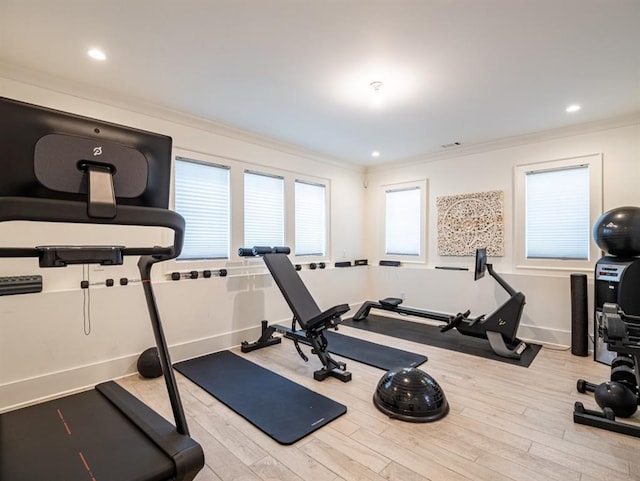 workout room featuring light wood-style flooring, baseboards, crown molding, and recessed lighting