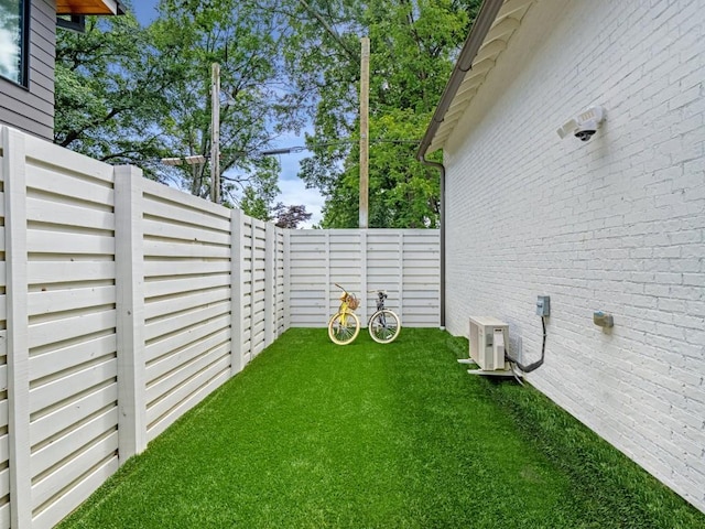 view of yard with ac unit and a fenced backyard