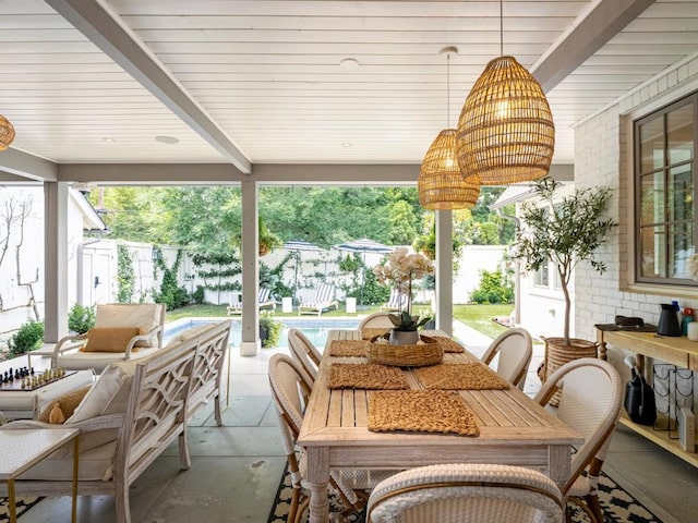 sunroom / solarium featuring beamed ceiling