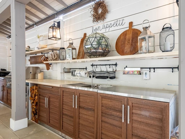 bar with a sink and decorative light fixtures