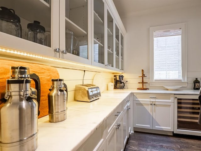 bar with dark wood-type flooring, beverage cooler, and decorative backsplash