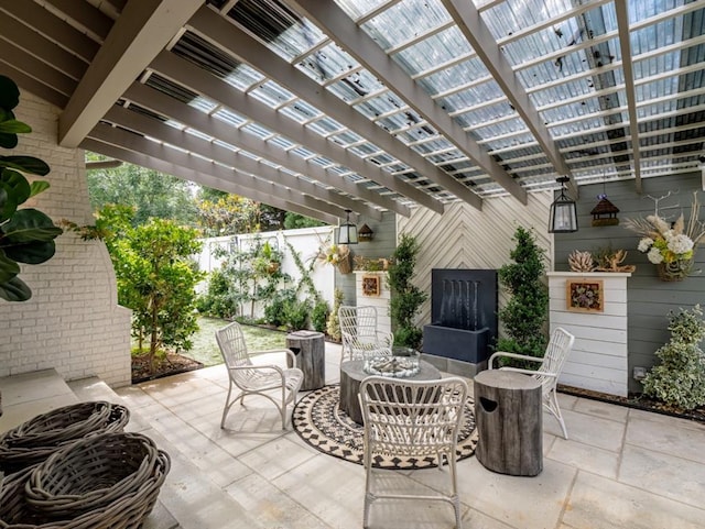 view of patio / terrace with fence, outdoor dining area, and a pergola