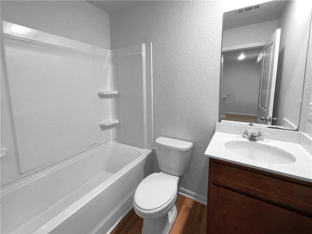 full bath with shower / washtub combination, visible vents, toilet, vanity, and wood finished floors