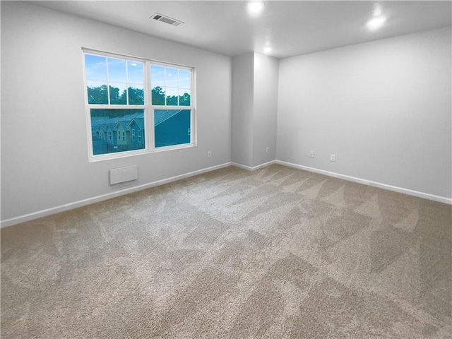 empty room featuring recessed lighting, carpet flooring, visible vents, and baseboards