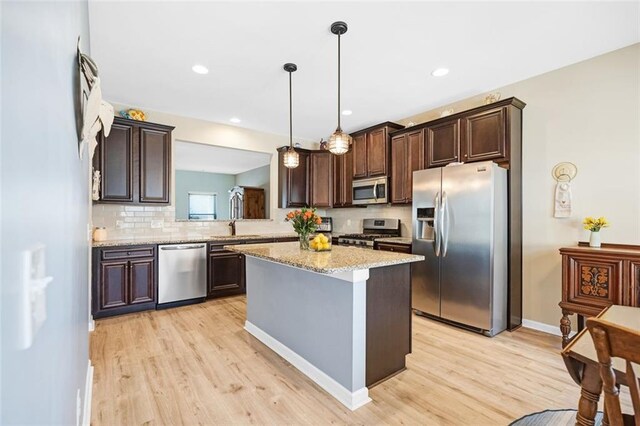 dining room featuring baseboards, visible vents, an inviting chandelier, and light wood-style floors