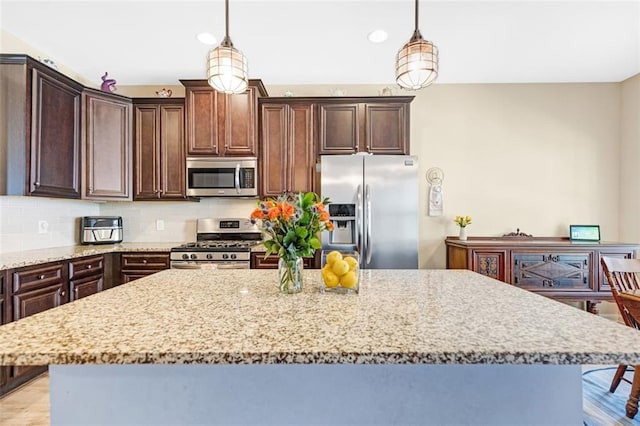 dining room featuring baseboards, an inviting chandelier, wood finished floors, and visible vents