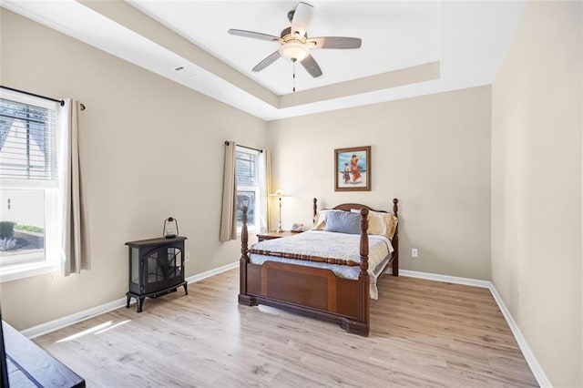 living room featuring a fireplace, baseboards, and light wood-style floors