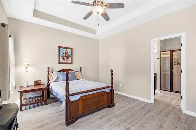 living area featuring baseboards, a fireplace, and light wood finished floors
