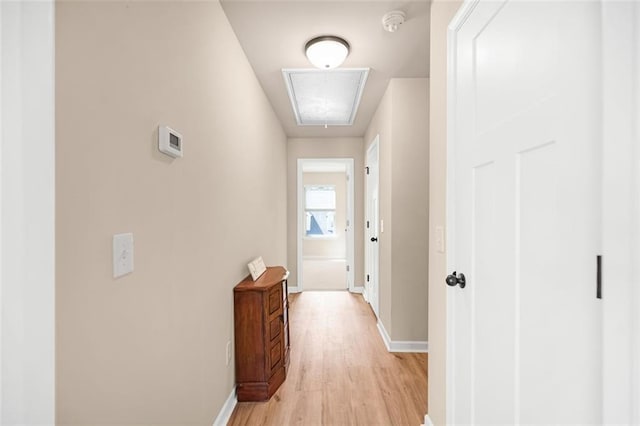 bathroom featuring visible vents, double vanity, wood finished floors, baseboards, and a sink
