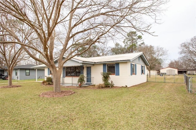 ranch-style house with metal roof, a front yard, fence, and a gate