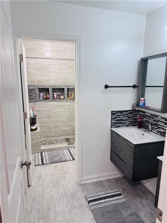 bathroom with vanity and a shower