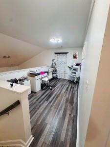 additional living space with dark hardwood / wood-style flooring and lofted ceiling