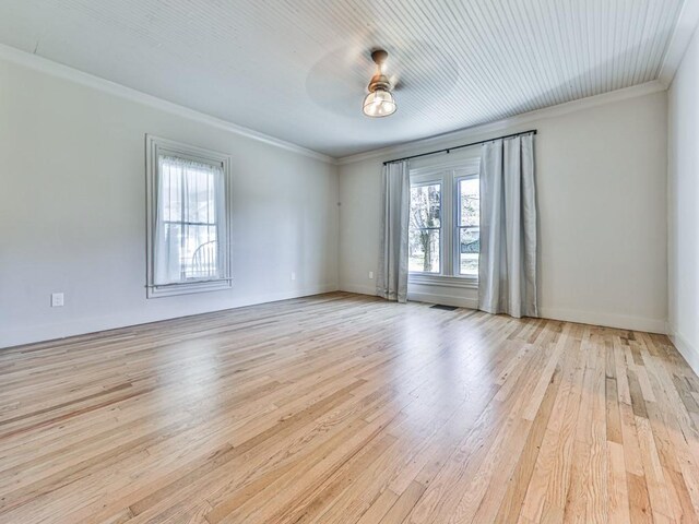 empty room with ceiling fan, light hardwood / wood-style floors, and crown molding