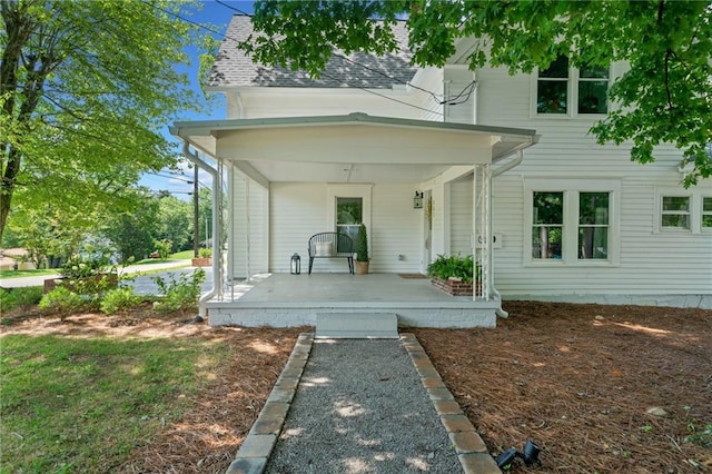 back of property with a porch