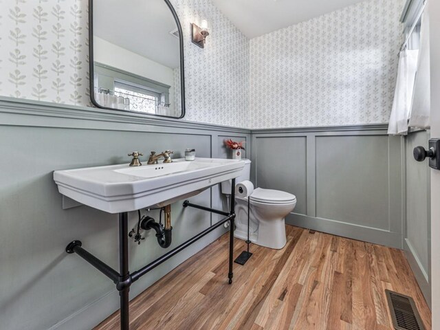 bathroom featuring hardwood / wood-style floors and toilet