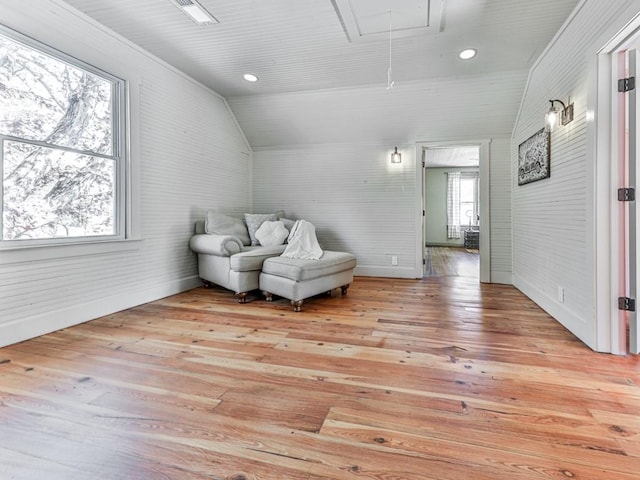 living area with light wood-type flooring and lofted ceiling