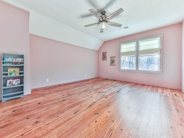 interior space with ceiling fan, vaulted ceiling, and light wood-type flooring