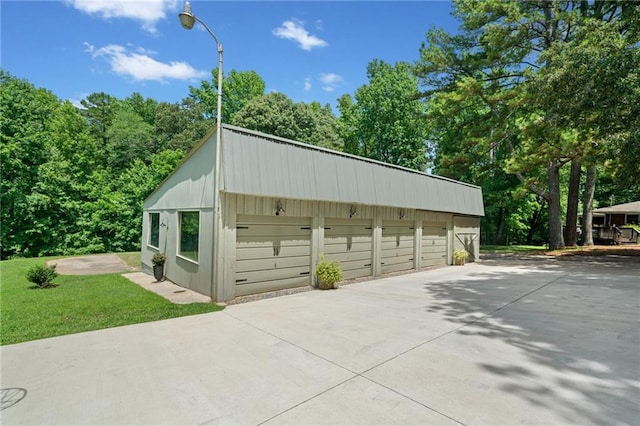 exterior space with a yard and a garage