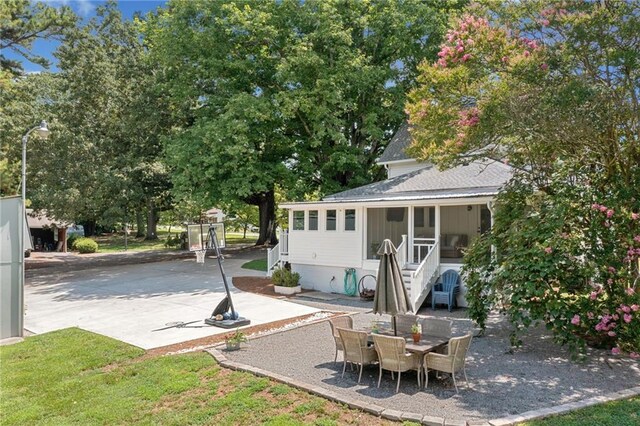 view of patio / terrace featuring a sunroom