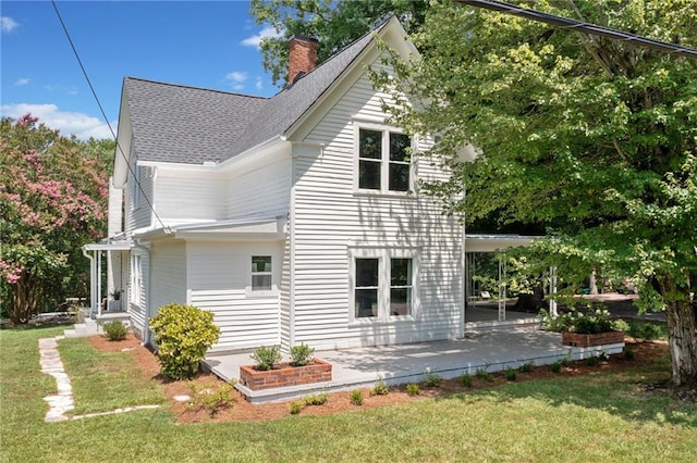 view of home's exterior with a lawn and a patio area