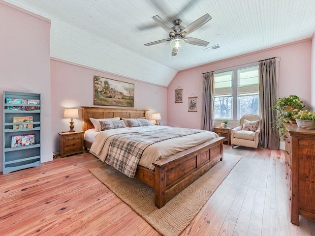 bedroom featuring ceiling fan, light hardwood / wood-style floors, and lofted ceiling