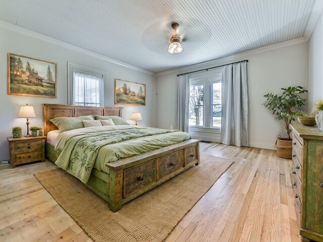 bedroom featuring light hardwood / wood-style flooring, multiple windows, and ceiling fan