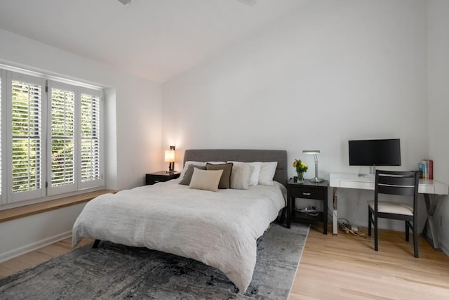 907 Edgewood Ave NE, Atlanta, GA 30307 - bedroom featuring wood finished floors, lofted ceiling, and baseboards