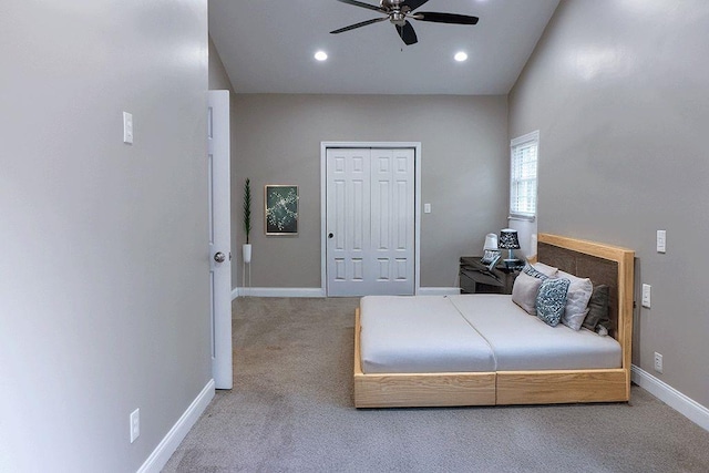 bedroom featuring ceiling fan, light carpet, and a closet