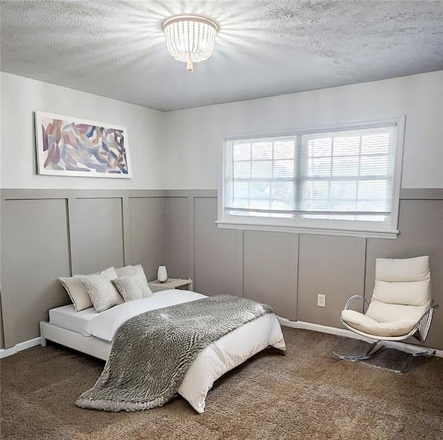 bedroom with carpet flooring and a textured ceiling