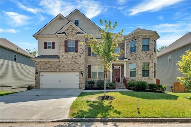 craftsman-style home with a garage, driveway, brick siding, and a front yard