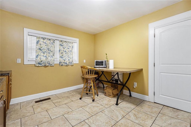 office space featuring light tile patterned floors, visible vents, and baseboards