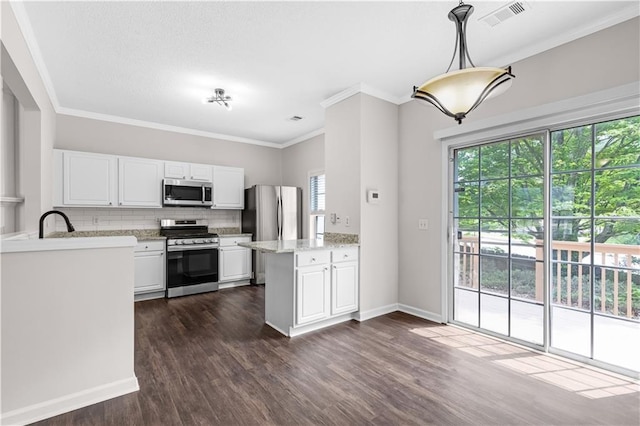 2754 Terrell Trace Dr, Marietta, GA 30067 - kitchen with stainless steel appliances, a peninsula, white cabinetry, dark wood-type flooring, and tasteful backsplash
