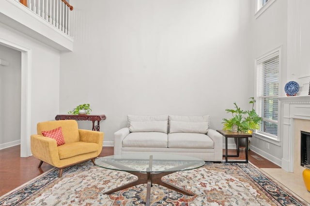 living room featuring hardwood / wood-style floors, a healthy amount of sunlight, and a high ceiling