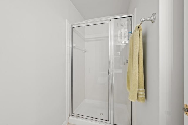 bathroom with a shower with door