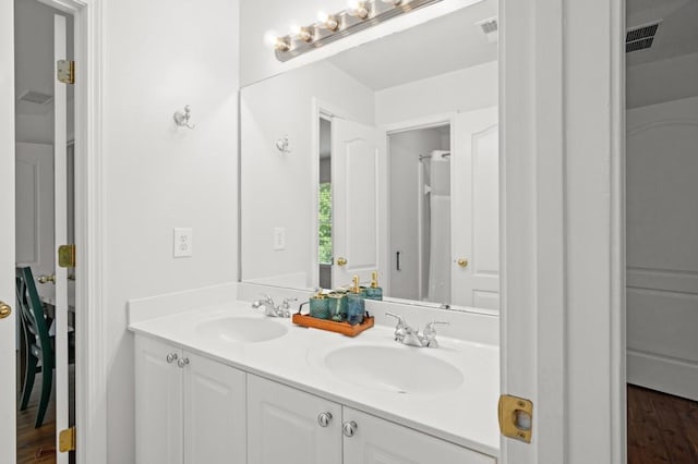 bathroom with hardwood / wood-style floors and vanity