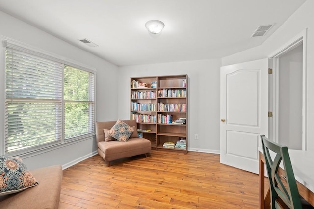 living area with plenty of natural light and light hardwood / wood-style floors