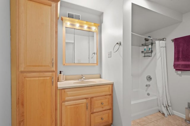 bathroom featuring tile patterned floors, vanity, and shower / bath combo