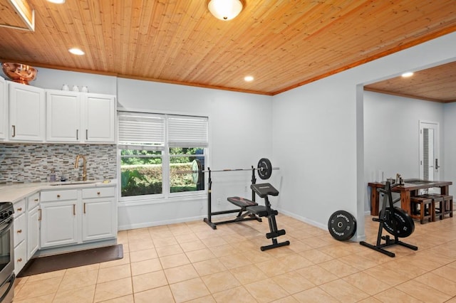 exercise room with crown molding, sink, light tile patterned floors, and wooden ceiling