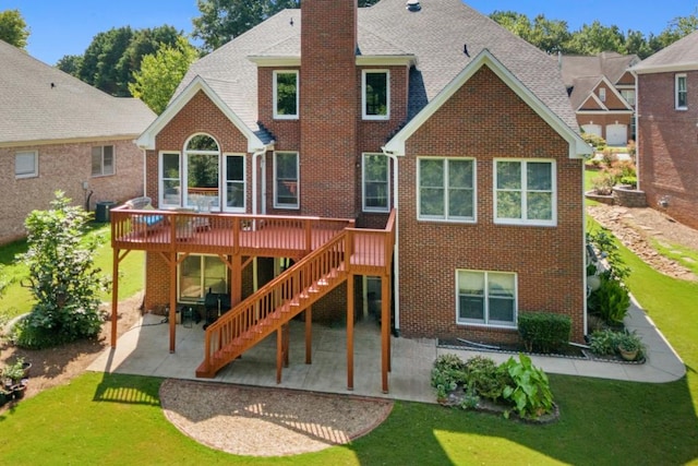 back of property with a yard, a patio, central AC unit, and a wooden deck