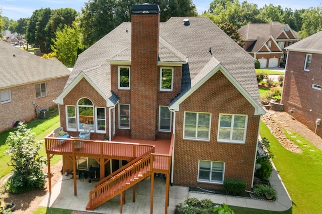 rear view of house featuring a patio area, central air condition unit, and a wooden deck