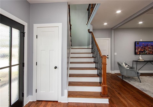 stairs featuring hardwood / wood-style flooring