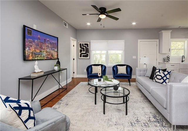 living room featuring ceiling fan and light wood-type flooring