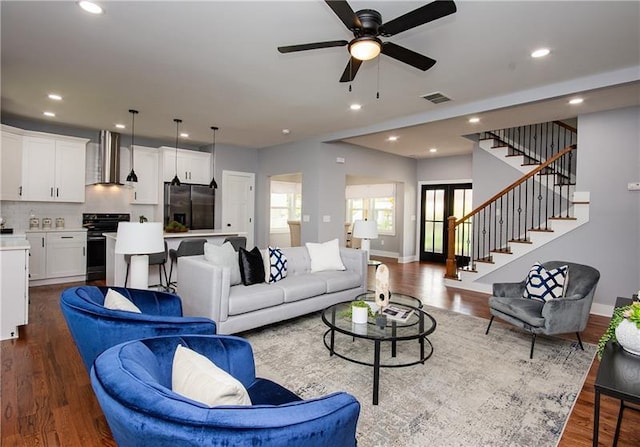 living room featuring hardwood / wood-style floors and ceiling fan