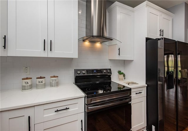 kitchen featuring white cabinetry, electric range oven, tasteful backsplash, black refrigerator with ice dispenser, and wall chimney exhaust hood