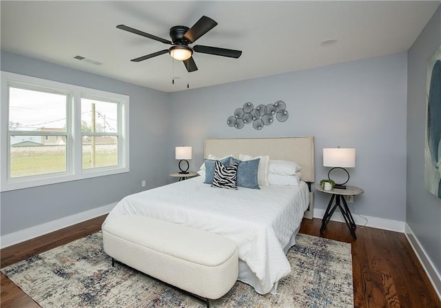 bedroom with ceiling fan and dark hardwood / wood-style floors