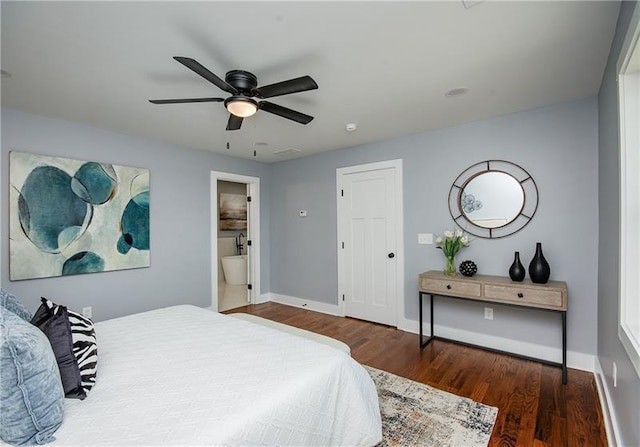 bedroom featuring dark wood-type flooring, ceiling fan, and ensuite bath