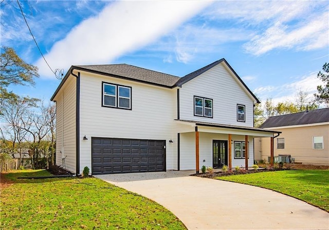 view of front of house featuring a garage, a front yard, and central air condition unit